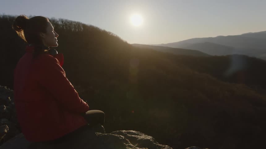 Woman enjoys mountain view on sunny winter day