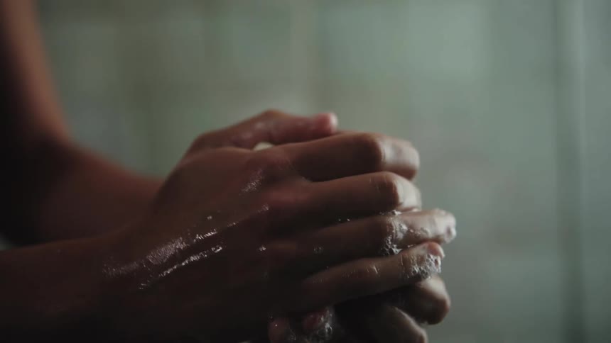 A person is washing their hands with a bar of soap