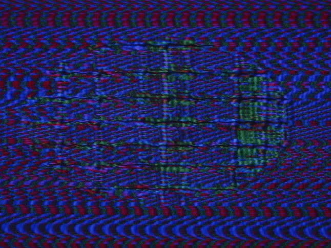 Signal noise distorts colorful pattern and blinking intermittent oval shape