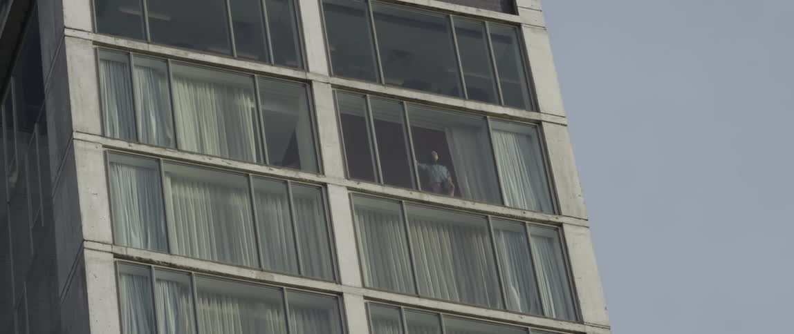 A man looks out his window