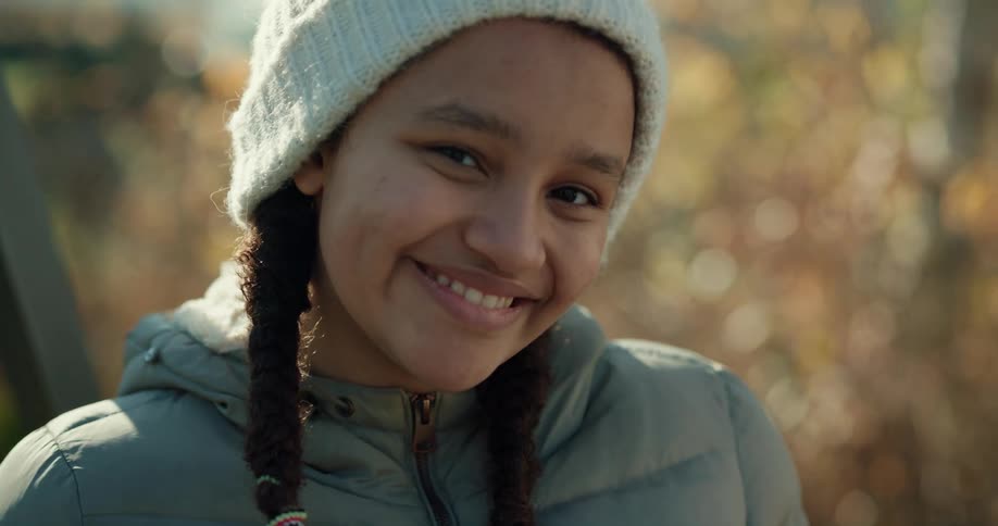 A child is smiling outside