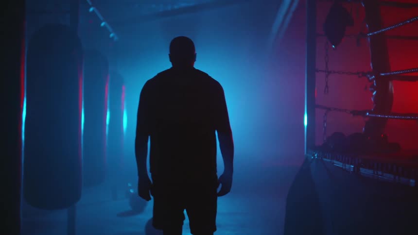 A man is walking through an empty gym