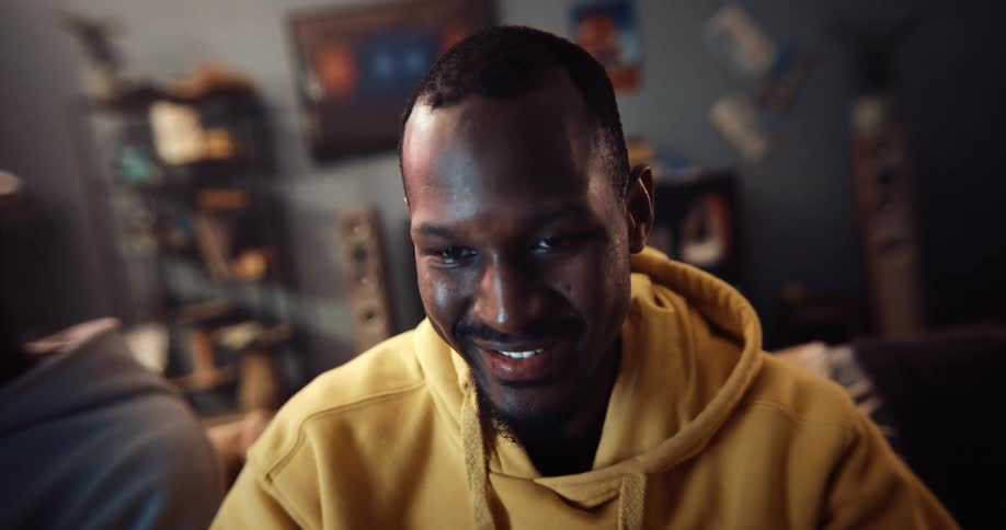A man is sitting on the couch smiling