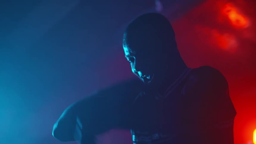 A man exercising in a dark room