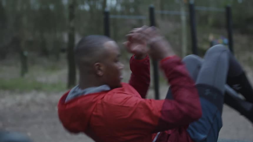 A man exercising in a wooden park