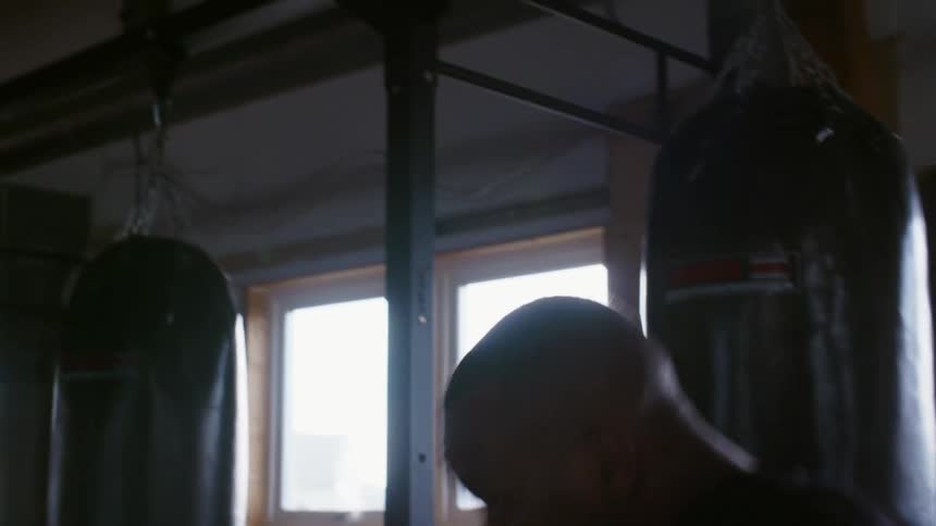 A man throws punches as he boxes