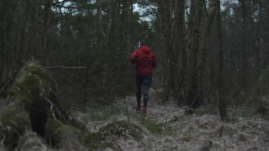 A man runs through a forest