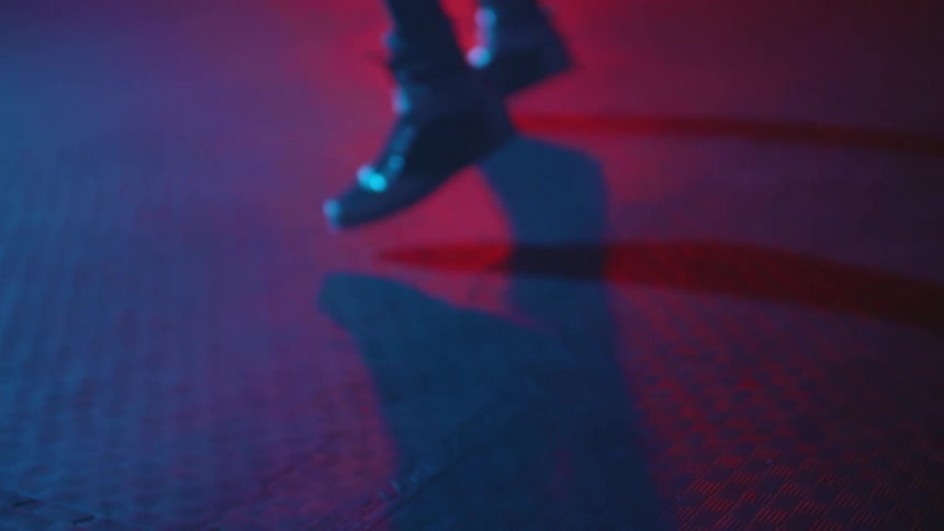 A man is in a room covered with mats and jumping around
