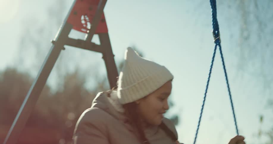 Children play on the swings in the playground