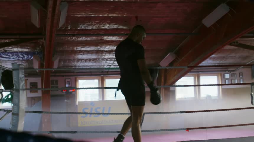 A man walks around a boxing ring