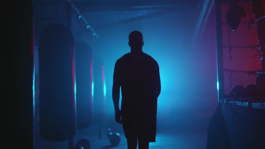 A man walks in the foggy gym