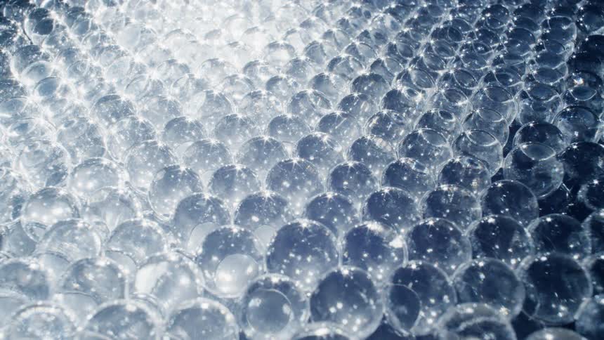 Light shines over clear globes causing them to shimmer