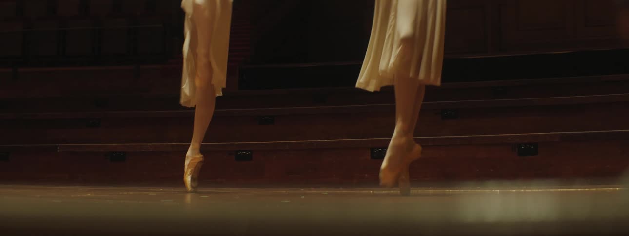 Two ballerinas dancing on stage