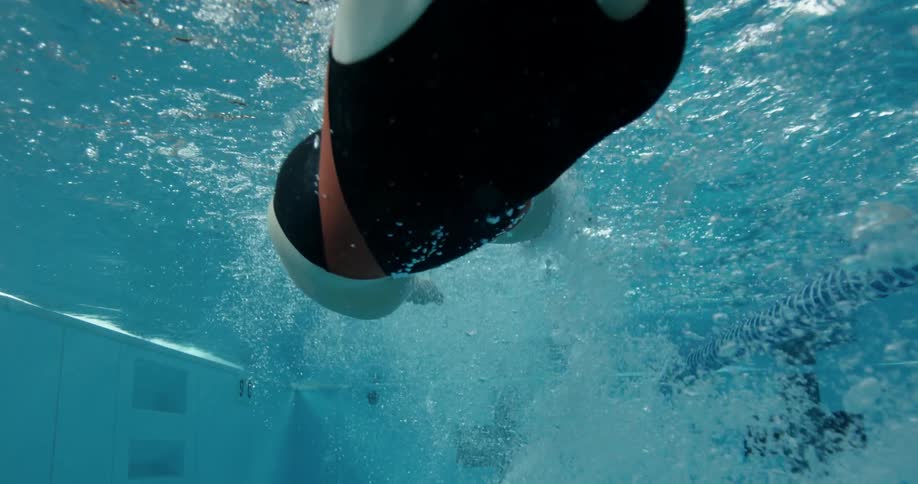 A woman in a one piece bathing suit is swimming