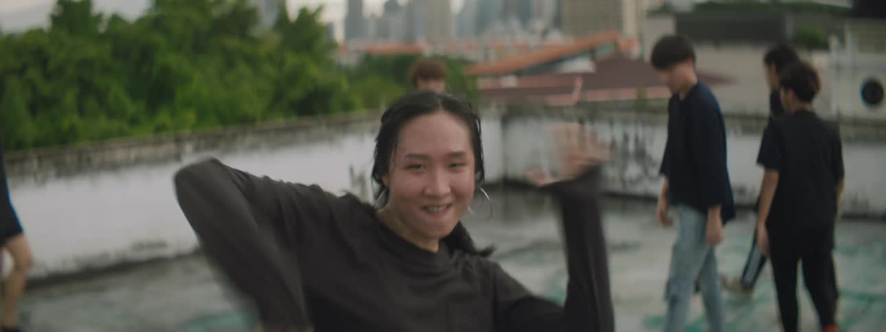 A group of teenagers dancing on a rooftop