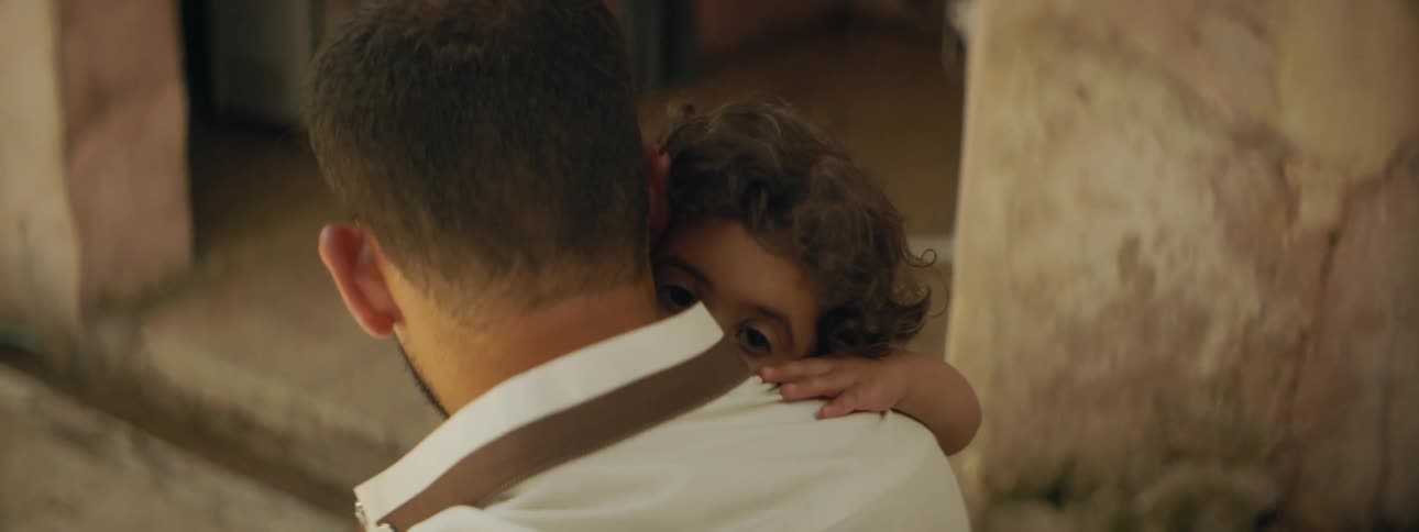 A man holding his young daughter in his arms