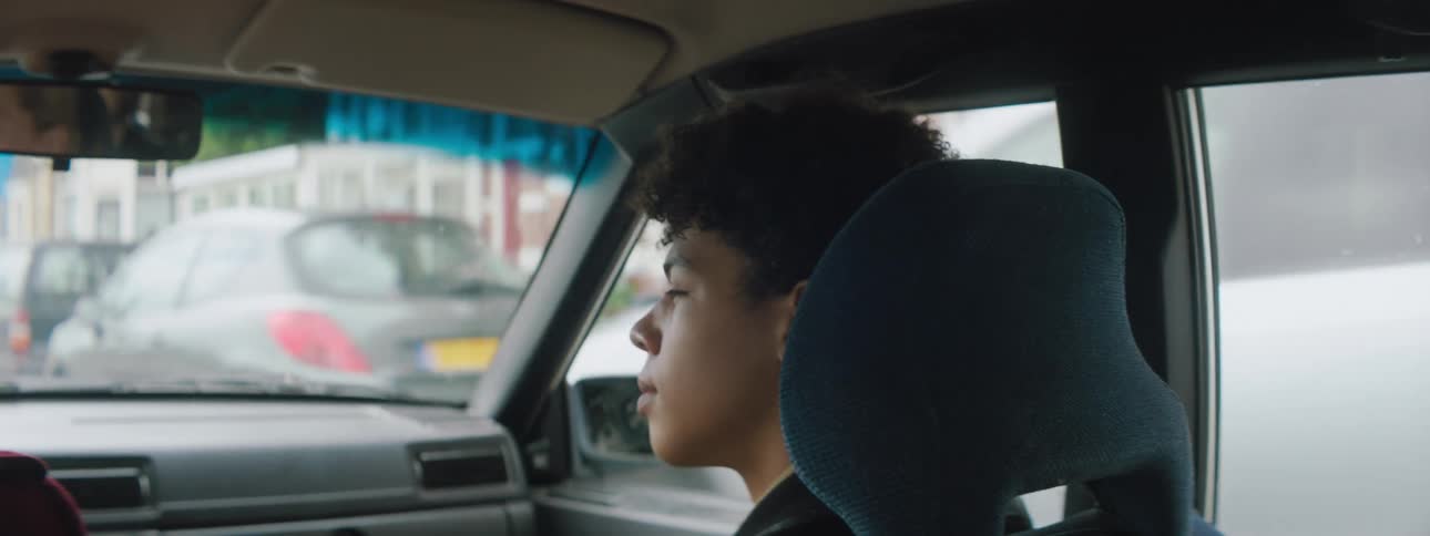 Woman sitting in car thinking deeply