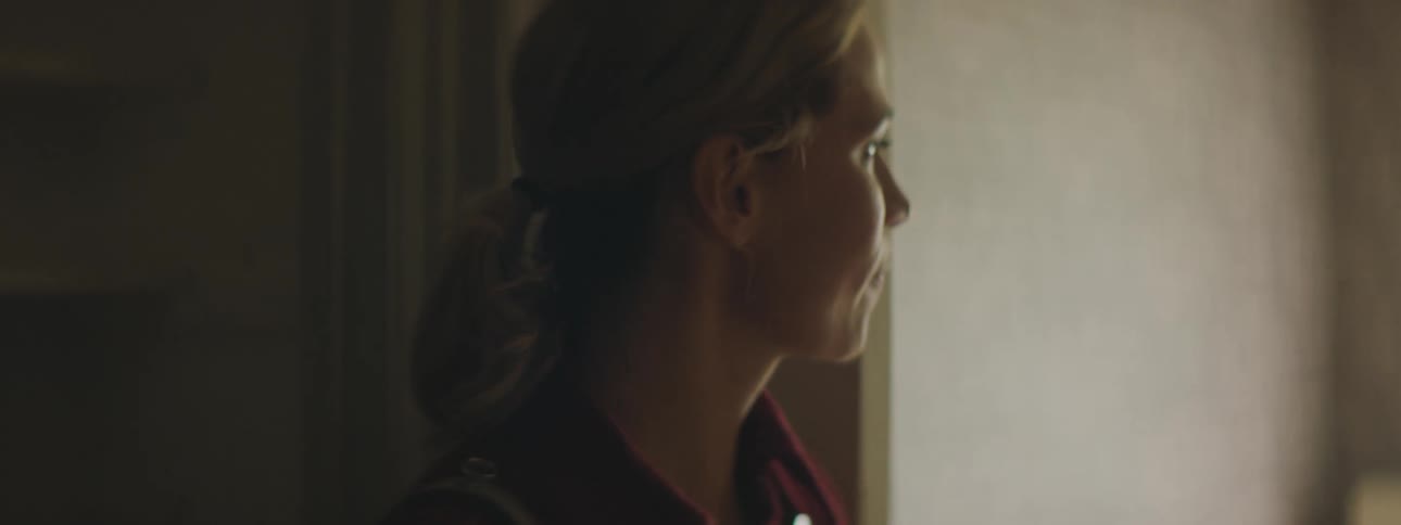 A woman is standing indoors during the day