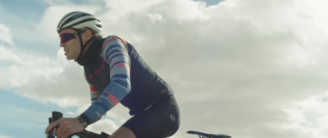 A cyclist pedals hard while cycling during the day