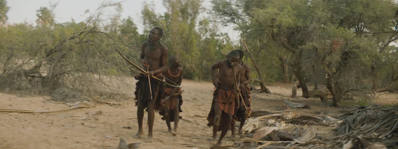 A group of villagers hunt with bows and arrows