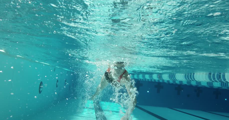 Woman swimming forward in a pool