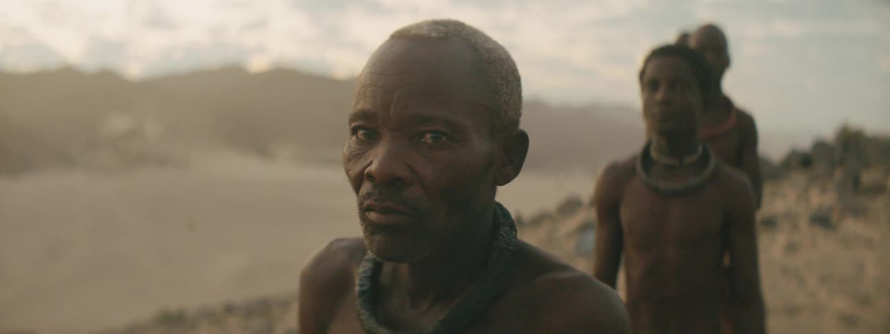 Members of a tribe standing outside