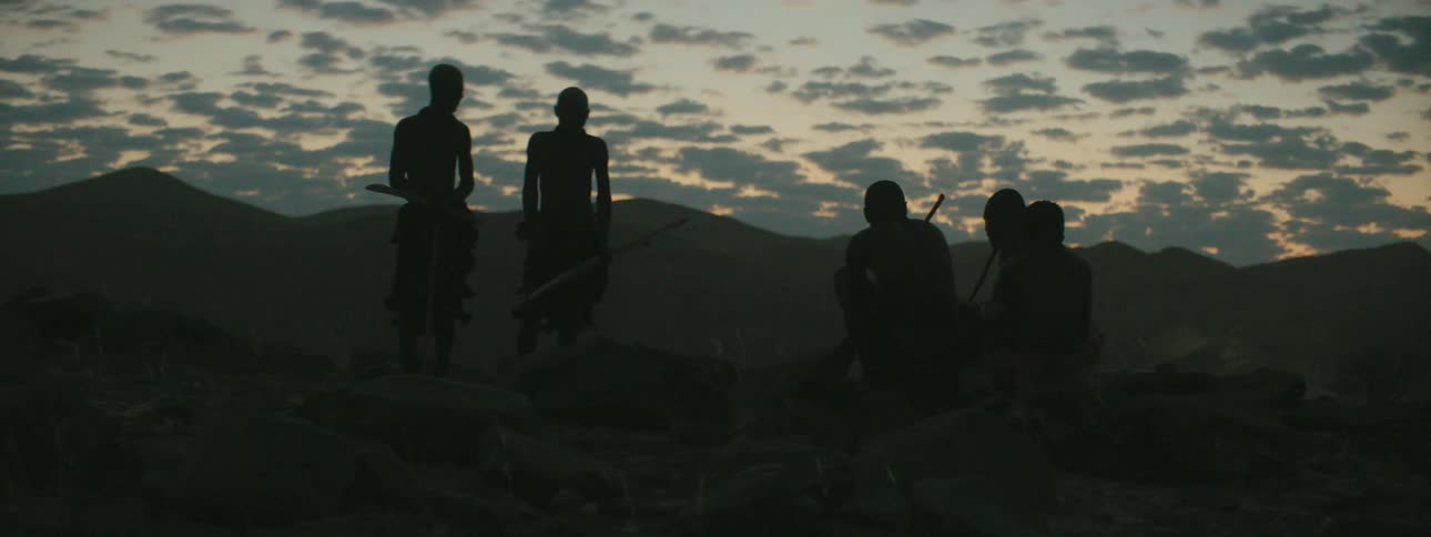 Tribe members outside at dusk