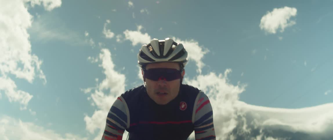 A man in a helmet riding a bicycle outdoors