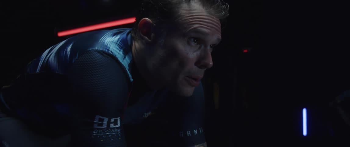 A man is exercising while using a stationary bike
