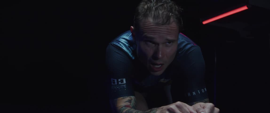 A man cycling in a room
