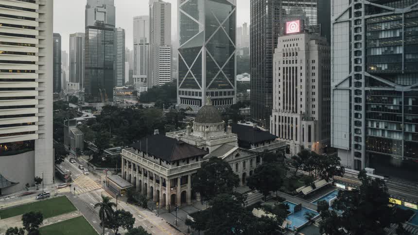 Hong kong city streets around the court of final appeal building are busy with people and traffic night and day