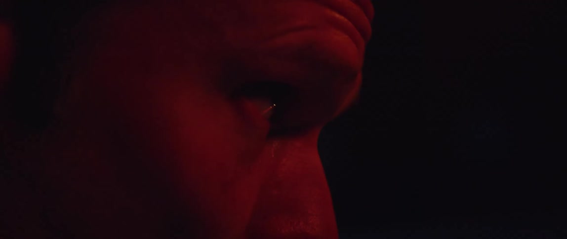 A man looks up in the dark