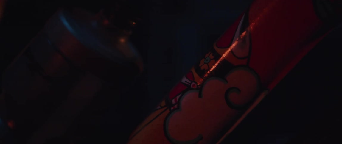 Light reflects off a tattoo on an arm