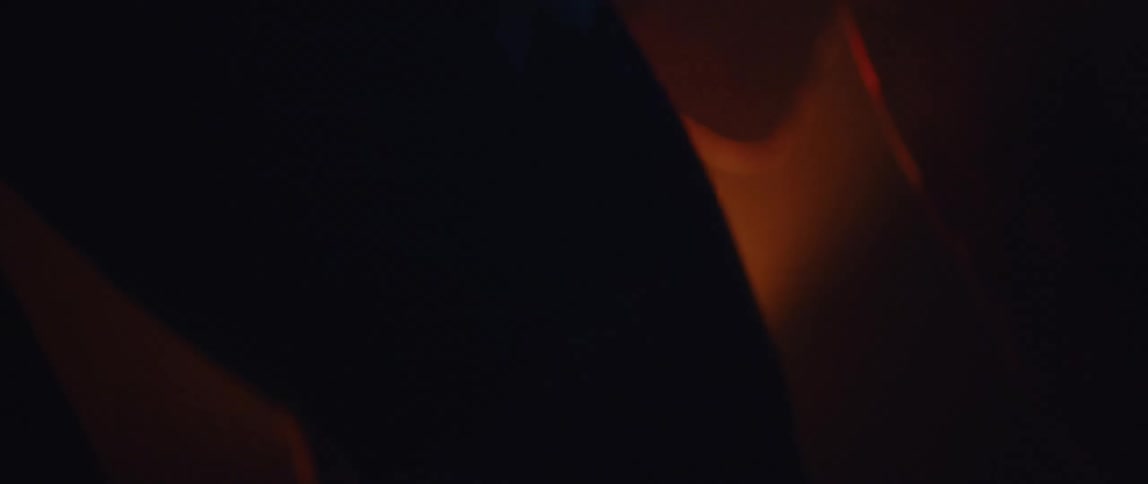 A person riding a stationary bike in front of a bright light