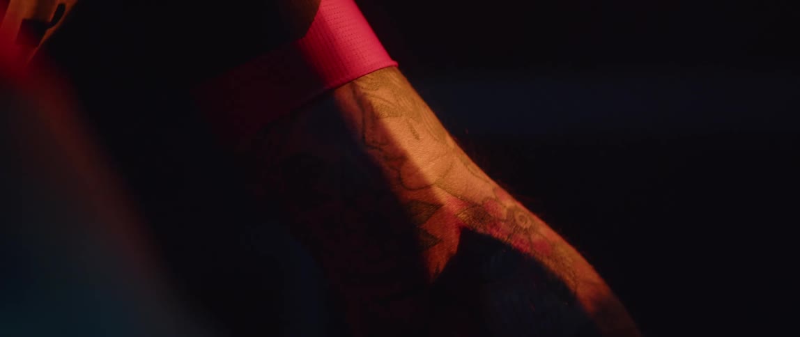 A tattoo of a woman with a flower is on a persons arm