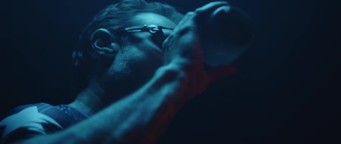 A man is drinking from his water bottle