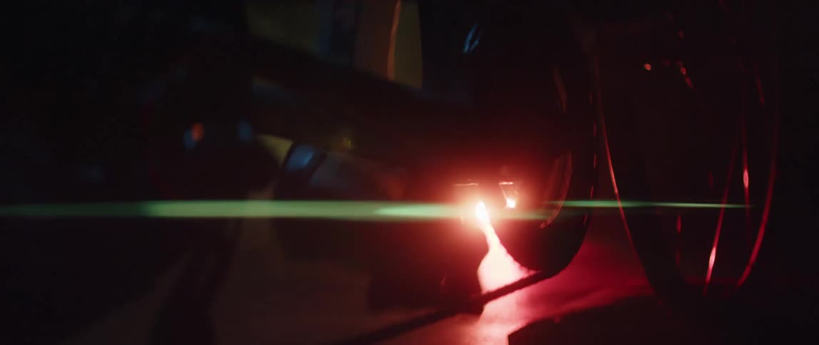 Feet pedaling a stationary bike in front of a bright light
