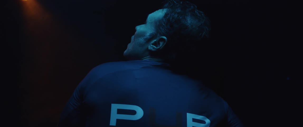 A man looks up in the dark