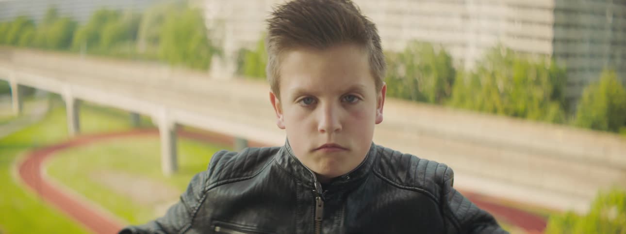 A young boy frowning outside