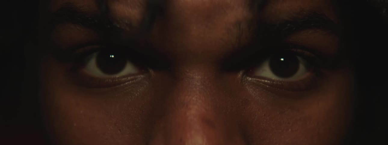 A man has his eyes closed and then opens them wide