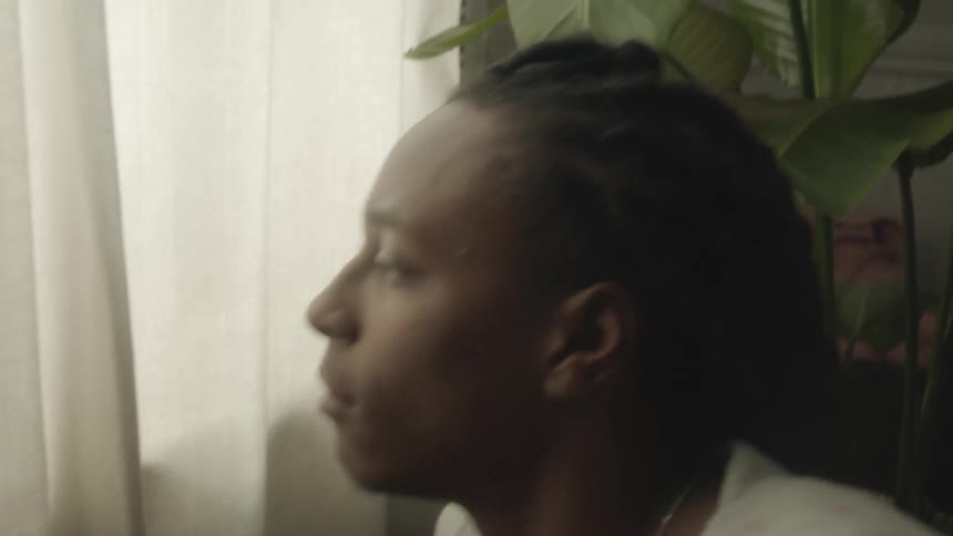 A man sits up by the window