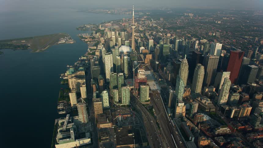 Downtown toronto with cn tower and skyscrapers and traffic moving on the highways