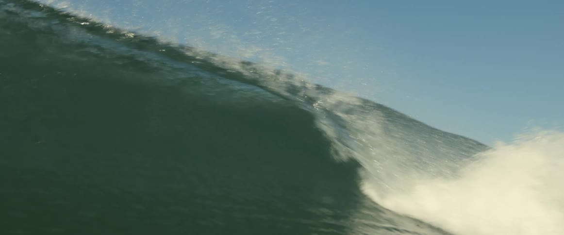 A wave rolls in and crashes over