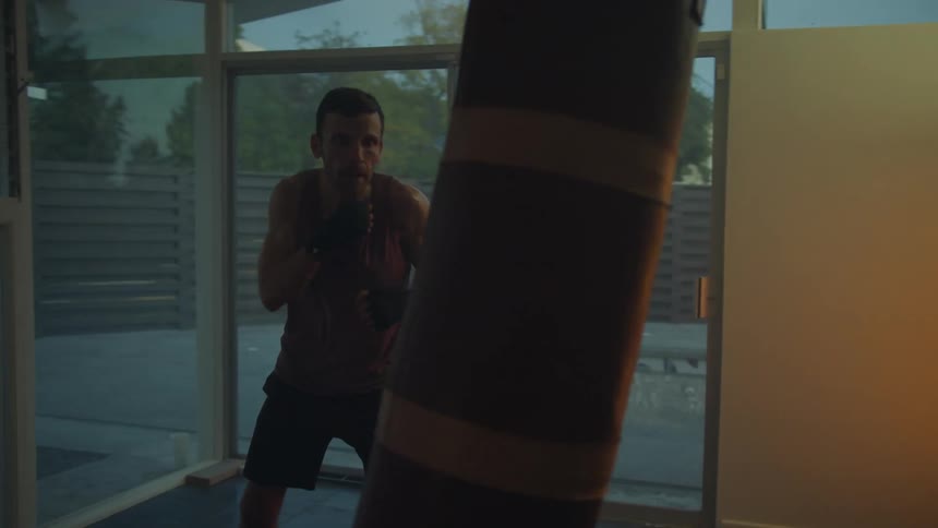 A man boxing in a room