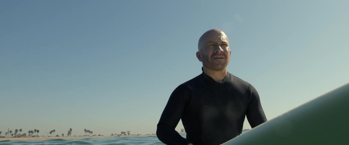 A man is surfing on ocean water during midday