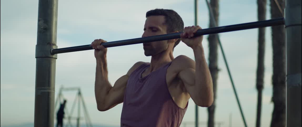 A man is exercising on equipment outdoors