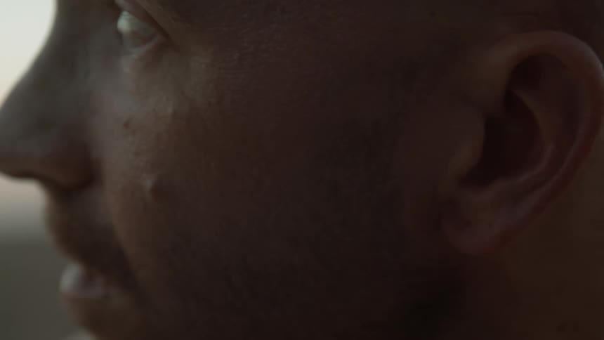 A close up view of a mans face is displayed