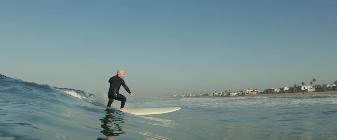A man is surfing on a wave