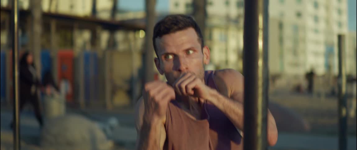 A man is shadowboxing outside