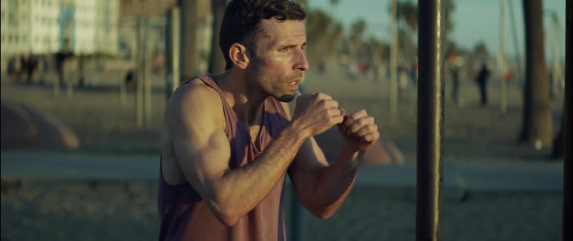 A man is shadowboxing outside